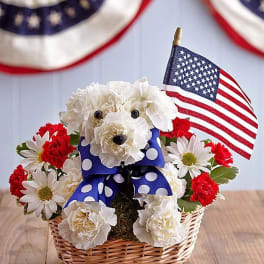 Flower arrangement shaped like a dog with an American flag