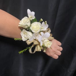 White rose wrist corsage with small white orchids and gold ribbon