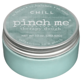 A teal tin labeled "pinch me therapy dough"