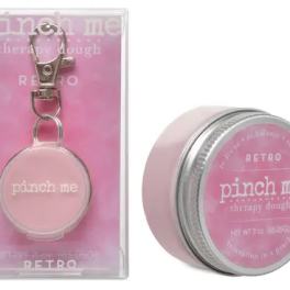 Pink therapy dough tin and matching keychain in clear packaging