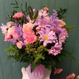 Pink and lavender mixed bouquet in a textured pink vase