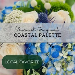 Blue and white floral arrangement with roses and hydrangeas