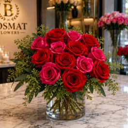 Bouquet of red and pink roses in a clear glass vase