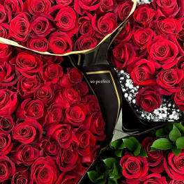 Bouquets of red roses with black wrapping and baby's breath
