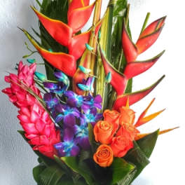 Tropical bouquet with red heliconia, orange roses, and purple orchids in a white vase