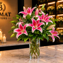 Pink lilies arranged in a clear glass vase