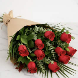 Bouquet of red roses wrapped in tan paper