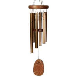 Wooden wind chime with gold metal tubes and a hanging wooden clapper
