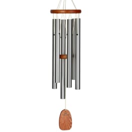 Metal wind chime with wooden accents hanging on a white background