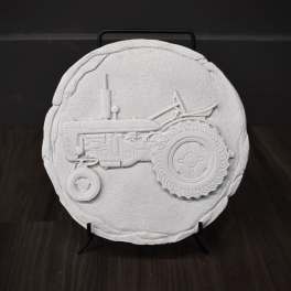 Round white decorative plaque with a raised tractor design