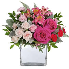 Pink and white rose bouquet in a clear square vase