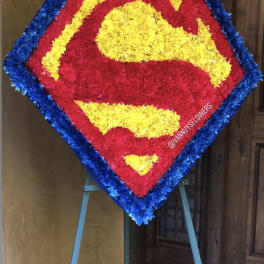 Superman logo floral tribute on an easel