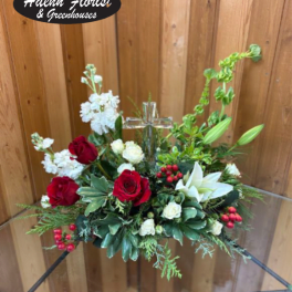 Red and white floral arrangement with a clear glass cross centerpiece