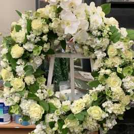 Large white floral wreath with roses and orchids