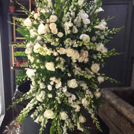 Large white floral standing spray with roses and snapdragons