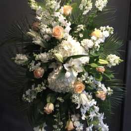 Tall white and peach floral standing spray with roses and lilies