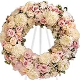 Round floral wreath of pale pink and cream roses