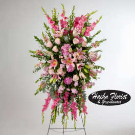 Tall pink floral standing spray on a metal easel