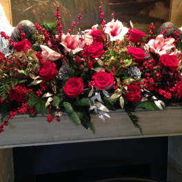 Long floral arrangement with red roses and pink lilies