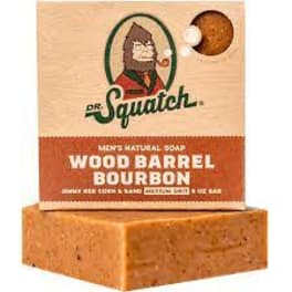 Boxed Dr. Squatch Wood Barrel Bourbon soap on a wooden block