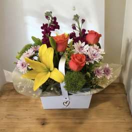 Mixed bouquet with roses, lilies, and daisies in a white gift box