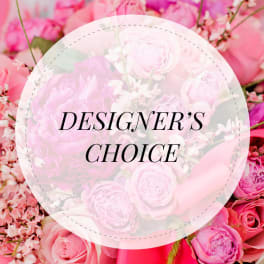 Pink floral arrangement with a "Designer’s Choice" label
