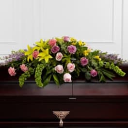 Casket spray with pink and yellow flowers