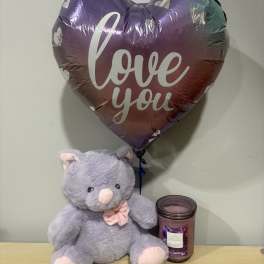 Heart-shaped "love you" balloon with a plush teddy bear and candle