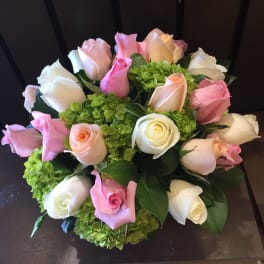 Bouquet of pink, white, and peach roses with green hydrangeas