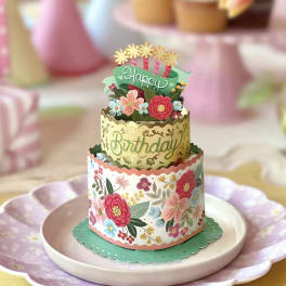 Tiered birthday card with floral decorations on a plate