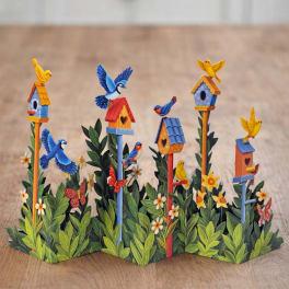Decorative paper birdhouses with colorful birds and flowers