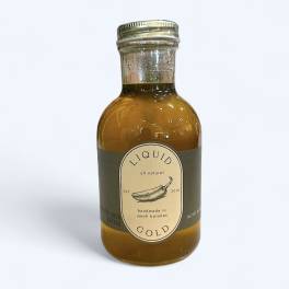 Bottle of liquid gold sauce with a labeled cap