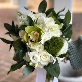 Hand-tied bouquet of white roses with green cymbidium orchid and mossy dianthus, finished with white ribbon tails