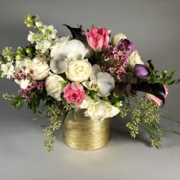 Bouquet of pink and white flowers in a gold vase