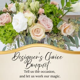 Mixed bouquet of pale roses and white blooms in a glass vase