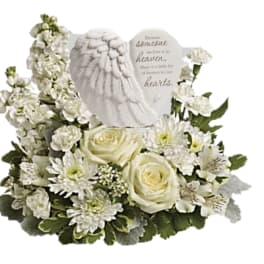White floral sympathy arrangement with roses and a memorial angel plaque