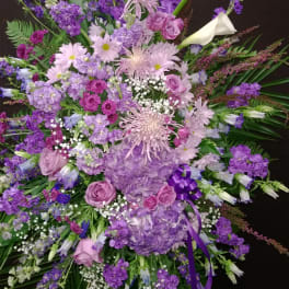 Large purple and pink floral spray with calla lilies and roses