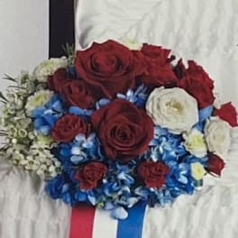 Red and white rose bouquet with blue flowers and ribbon tails