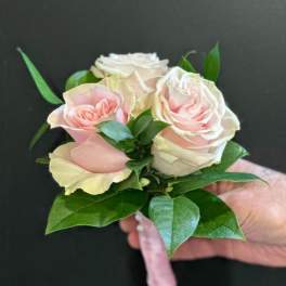 Small bouquet of pale pink roses with green leaves
