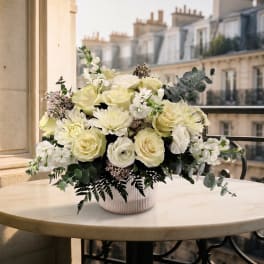 Cream rose and white chrysanthemum arrangement in a ribbed ceramic vase