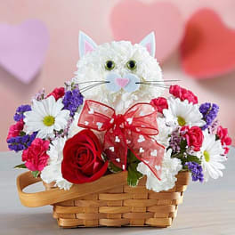 Cat-shaped floral basket with a red rose and daisies