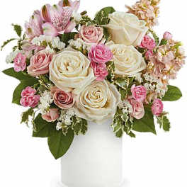 Pink and white rose bouquet in a white vase