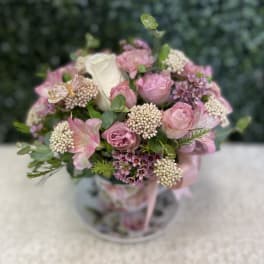Pink and white bouquet with roses in a clear vase