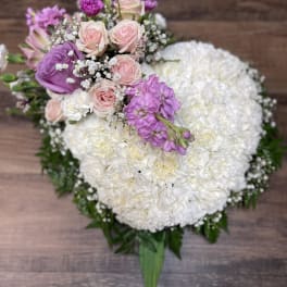 Heart-shaped bouquet of white and pink flowers with purple accents