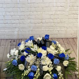 Blue and white floral spray with a black ribbon bow