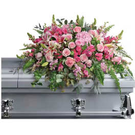 Pink floral spray on a silver casket