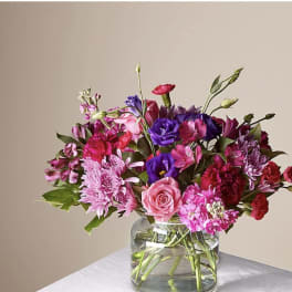 Mixed pink and purple bouquet in a clear glass vase
