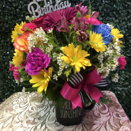 Colorful birthday bouquet in a black mug with a glittery topper
