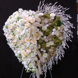 Heart-shaped white floral standing spray with roses and chrysanthemums