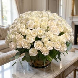 Large bouquet of white roses in a clear glass vase